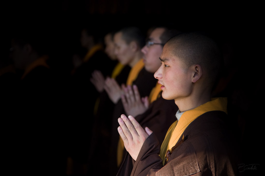 Buddhist monks praying inside the Fayuan temple in Beijing