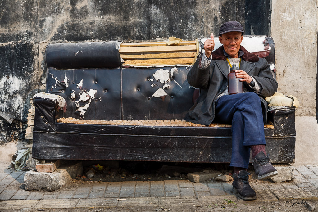 An old sofa used as a bench in a hutong. Beijing. 09.03.08