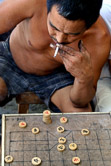 A Chinese worker playing Xiangqi in a hutong in Beijing. 11.08.06