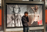 A young man waiting for the bus in Beijing city center. 27.10.11