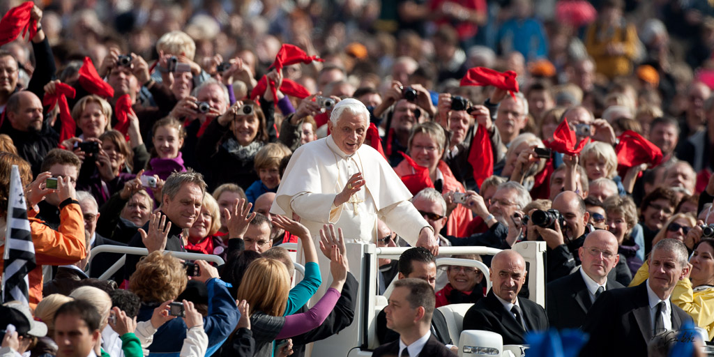 Faithful waves to the Pope Benedict XVI as he arrives to lead his weekly audience in St. Peter's square. Vatican City, october 22, 2010.