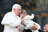 Pope Benedict XVI kisses a baby at the end of his weekly audience in St. Peter's square. Vatican City, June 2, 2010.
