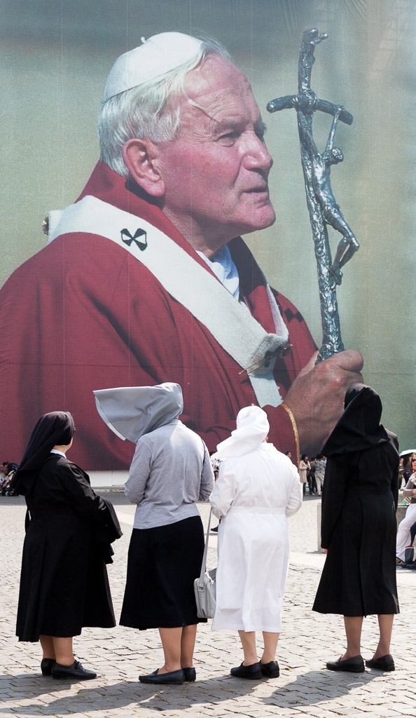 A group of four nuns looking at the huge John Paul II's placard in St. Peter's square three days before his beatification. Vatican City, April 28, 2011.