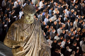 Priests under the St. Peter statue praying with the Pope Benedict XVI as he leads the prayer vigil with priests in st. Peters' square during the final day of the Vatican's Year for Priests, Vatican city,  June 10, 2010.
